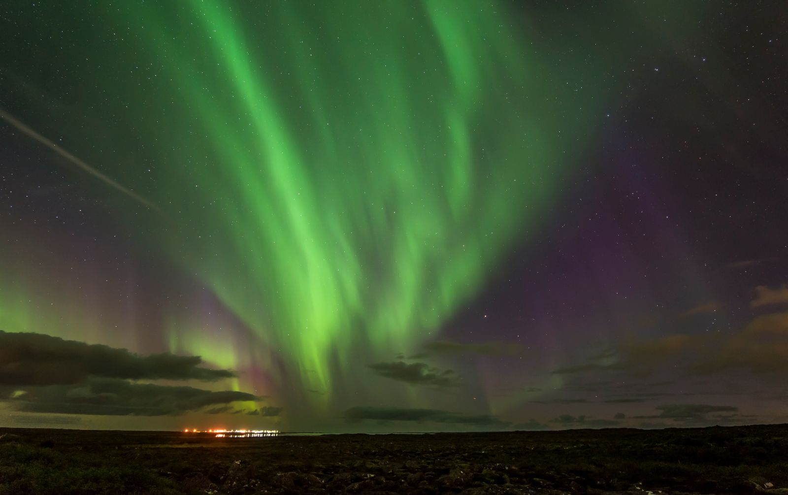 Green aurora borealis over an Icelandic landscape